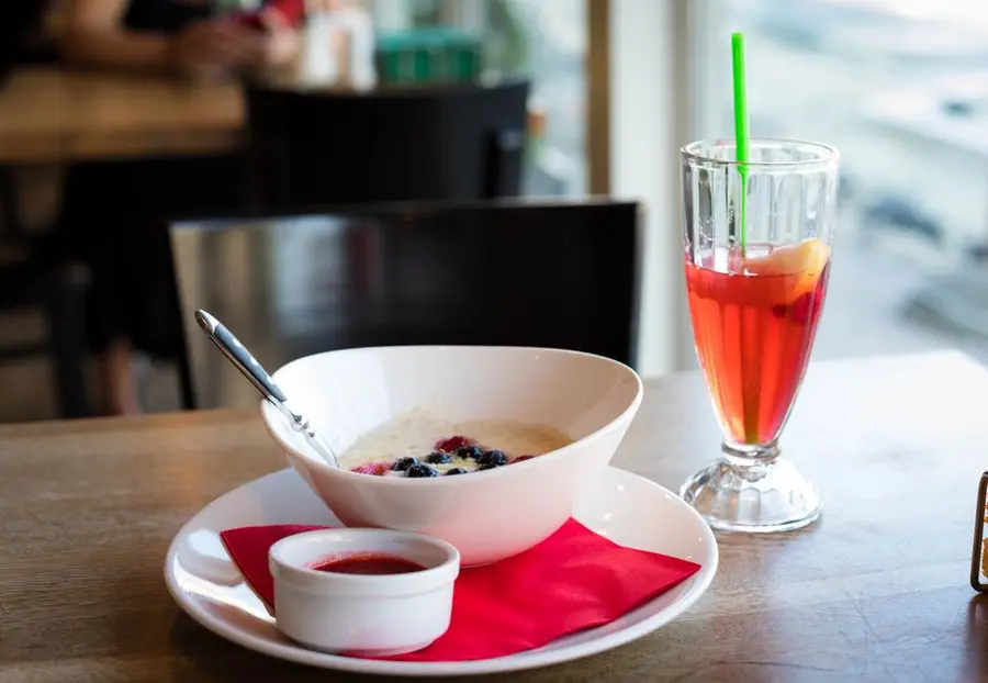 Breakfast table with a bowl of porridge and fruit, the morning routine the product is meant to fit into