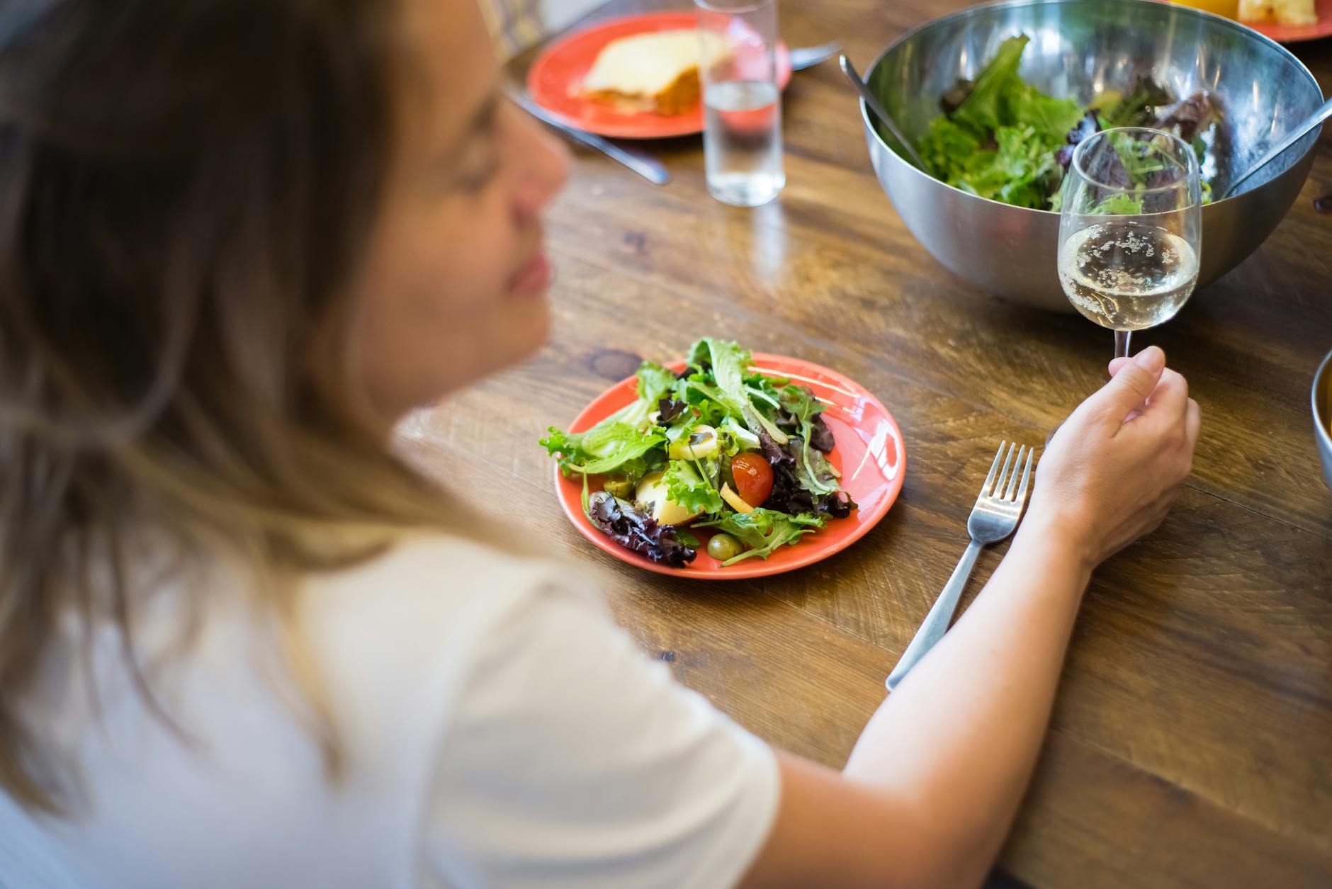 woman eating healthy salad meal during eating window intermittent fasting
