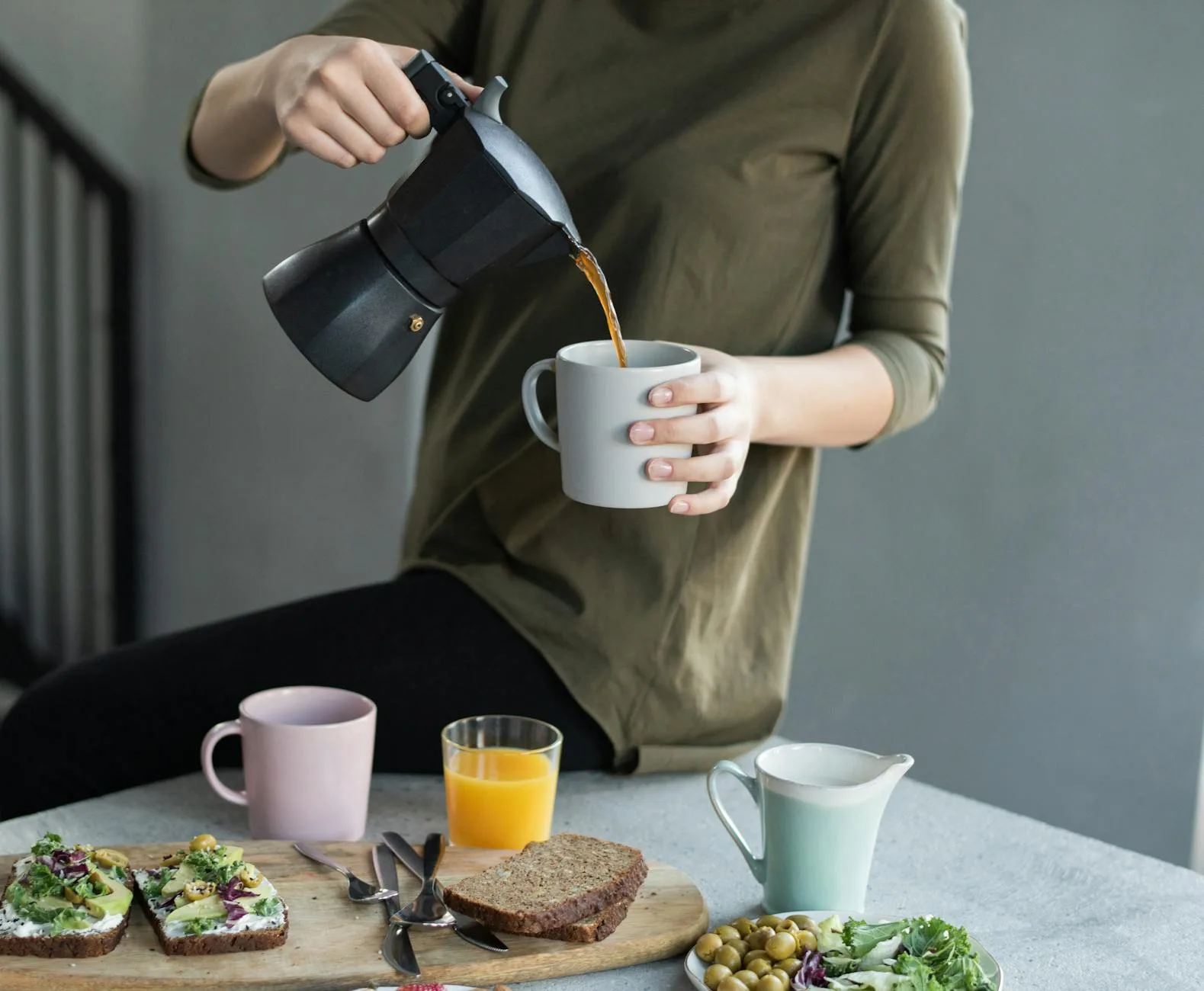 Woman in her 50s holding a cup of black coffee, healthy prediabetes lifestyle
