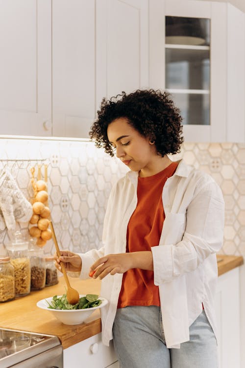 Woman preparing a colorful healthy salad to reverse prediabetes naturally