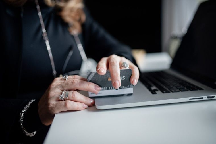 person shopping online with credit card