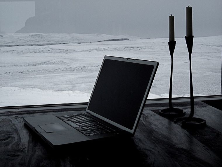 person writing review on laptop at home